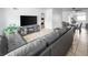 Spacious living room featuring tile flooring, a modern entertainment center and a large sectional sofa at 2829 W College Ave, Denver, CO 80219
