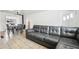 Comfortable living room featuring stylish sofa and tile flooring adjacent to dining area with ceiling fan at 2829 W College Ave, Denver, CO 80219