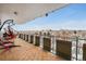 Enjoy city views from this spacious balcony with a swing chair, unique tile flooring, and metal railings for safety at 800 N Washington St # 710, Denver, CO 80203