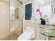 Bathroom featuring glass enclosed shower, modern toilet, and unique glass sink with modern hardware at 800 N Washington St # 710, Denver, CO 80203