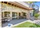 A cozy back patio with a spiral staircase features stone accents, seating, and access to the backyard at 12 Canon Cir, Greenwood Village, CO 80111