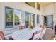 An outdoor deck boasts a table with colorful striped chairs and multiple windows for abundant natural light at 12 Canon Cir, Greenwood Village, CO 80111