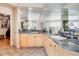 Bright bathroom with dual sinks, mirrored walls, and walk-in closet at 12 Canon Cir, Greenwood Village, CO 80111