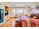 Sunlit bedroom boasts a gas fireplace, hardwood floors, comfortable seating, and a cozy bed with striped bedding and throw pillows at 12 Canon Cir, Greenwood Village, CO 80111