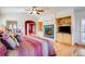 Cozy bedroom with fireplace, hardwood floors, and a comfortable bed with striped bedding and throw pillows at 12 Canon Cir, Greenwood Village, CO 80111