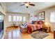 Bright bedroom features hardwood floors, a sitting area near the window, and a cozy, striped bed with decorative pillows at 12 Canon Cir, Greenwood Village, CO 80111