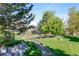 Picturesque community grounds with a pond, fountain, mature trees, and walking paths at 12 Canon Cir, Greenwood Village, CO 80111