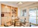 Bright dining area with built-in shelves, patio access, and view to the exterior at 12 Canon Cir, Greenwood Village, CO 80111