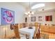 Elegant dining area with a chandelier, artwork, and a bright window at 12 Canon Cir, Greenwood Village, CO 80111