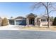 Charming stone home featuring a two-car garage and inviting front entrance at 12 Canon Cir, Greenwood Village, CO 80111