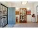 Inviting home foyer showcasing a display case with art and tile flooring at 12 Canon Cir, Greenwood Village, CO 80111