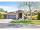 Charming single-story home features a stone facade, attached garage, and beautifully landscaped front yard at 12 Canon Cir, Greenwood Village, CO 80111
