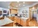 Bright kitchen features wood cabinets, stainless steel appliances and marble countertops with an island cooktop at 12 Canon Cir, Greenwood Village, CO 80111