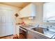 This laundry room features a front loading washer and dryer with storage cabinets above and a folding counter to the side at 12 Canon Cir, Greenwood Village, CO 80111