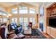 Open living area with large windows, fireplace, and comfortable leather seating at 12 Canon Cir, Greenwood Village, CO 80111