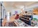 Open-concept living room showcasing vaulted ceilings and seamless flow to the dining area at 12 Canon Cir, Greenwood Village, CO 80111