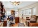 Well-lit office featuring wood floors, a ceiling fan, built-in shelves, and shuttered windows at 12 Canon Cir, Greenwood Village, CO 80111
