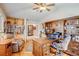 Comfortable office with wood floors, a ceiling fan, built-in bookshelves, and a cozy armchair at 12 Canon Cir, Greenwood Village, CO 80111