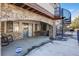 This is a concrete patio with stone arch and a spiral staircase with snow on the ground at 12 Canon Cir, Greenwood Village, CO 80111