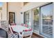 Relaxing patio with white dining table, chairs, and sliding glass doors with artistic accents at 12 Canon Cir, Greenwood Village, CO 80111