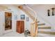 Elegant staircase with carpeted steps and wooden railing, complemented by unique decor and access to a wine cellar at 12 Canon Cir, Greenwood Village, CO 80111