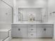 Bright bathroom with a double vanity, quartz countertop, and a glass enclosed shower at 2347 Kite Route Ln, Superior, CO 80027
