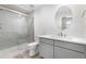 Bathroom with a glass-enclosed shower, modern vanity, and a round mirror at 2347 Kite Route Ln, Superior, CO 80027