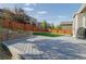 Gray composite deck in a backyard with landscaping and a wooden fence at 5759 Haywagon Ln, Castle Rock, CO 80108