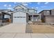 Two-story home featuring a two-car garage and a charming front porch at 1349 Brookfield Pl, Erie, CO 80026