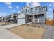 Two-story home featuring a two-car garage and a charming front porch at 1349 Brookfield Pl, Erie, CO 80026