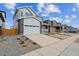 Two-story home featuring a two-car garage and a charming front yard at 1349 Brookfield Pl, Erie, CO 80026