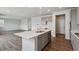 This modern kitchen features grey cabinets, a white countertop island with stainless dishwasher and double sink at 1349 Brookfield Pl, Erie, CO 80026