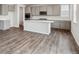 This modern kitchen features stylish grey cabinets, stainless appliances, and a center island with sink at 1349 Brookfield Pl, Erie, CO 80026