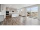 Bright eat-in kitchen featuring wood floors, white cabinets, island, and sliding glass doors to the outdoors at 1349 Brookfield Pl, Erie, CO 80026