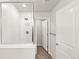 Bathroom featuring a glass-enclosed shower with neutral walls and tiling at 7306 Watercress Dr, Littleton, CO 80125