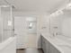 Bright bathroom features double sinks, modern fixtures, and access to living area at 7306 Watercress Dr, Littleton, CO 80125