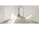 Neutral carpeted bedroom with double closet and view to hallway at 7306 Watercress Dr, Littleton, CO 80125