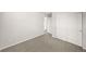 Carpeted bedroom with sliding closet and doorway to hall at 7306 Watercress Dr, Littleton, CO 80125