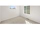 Bright carpeted bedroom with two windows and neutral walls at 7306 Watercress Dr, Littleton, CO 80125