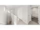 Bright hallway with white walls, carpet, closet, and bathroom view at 7306 Watercress Dr, Littleton, CO 80125