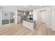 Modern kitchen boasts stainless appliances, a center island with pendant lights, and open flow to the dining area at 7306 Watercress Dr, Littleton, CO 80125