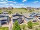 Stunning aerial view of homes featuring solar panels, with well-maintained yards and community spaces at 16486 W 94Th Dr, Arvada, CO 80007
