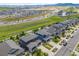 An aerial view of a suburban neighborhood showing rooftops, streets, and green spaces on a bright day at 16486 W 94Th Dr, Arvada, CO 80007