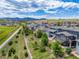 A picturesque aerial view of homes backing to a scenic greenbelt, nestled against a backdrop of mountains at 16486 W 94Th Dr, Arvada, CO 80007