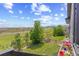 Inviting backyard view from the deck with manicured lawn, flowers, and an open green space at 16486 W 94Th Dr, Arvada, CO 80007