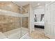 Bathroom featuring a tiled shower with glass doors and access to Primary bedroom at 16486 W 94Th Dr, Arvada, CO 80007