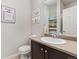 Well-lit bathroom with a vanity, toilet, and decor at 16486 W 94Th Dr, Arvada, CO 80007