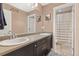 Bright bathroom featuring double sinks and access to shower room at 16486 W 94Th Dr, Arvada, CO 80007