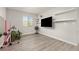 Neutral bedroom with wood-look floors, a large window, and shelving at 16486 W 94Th Dr, Arvada, CO 80007