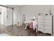 Charming bedroom with a white vanity, dresser, and a cozy chair at 16486 W 94Th Dr, Arvada, CO 80007